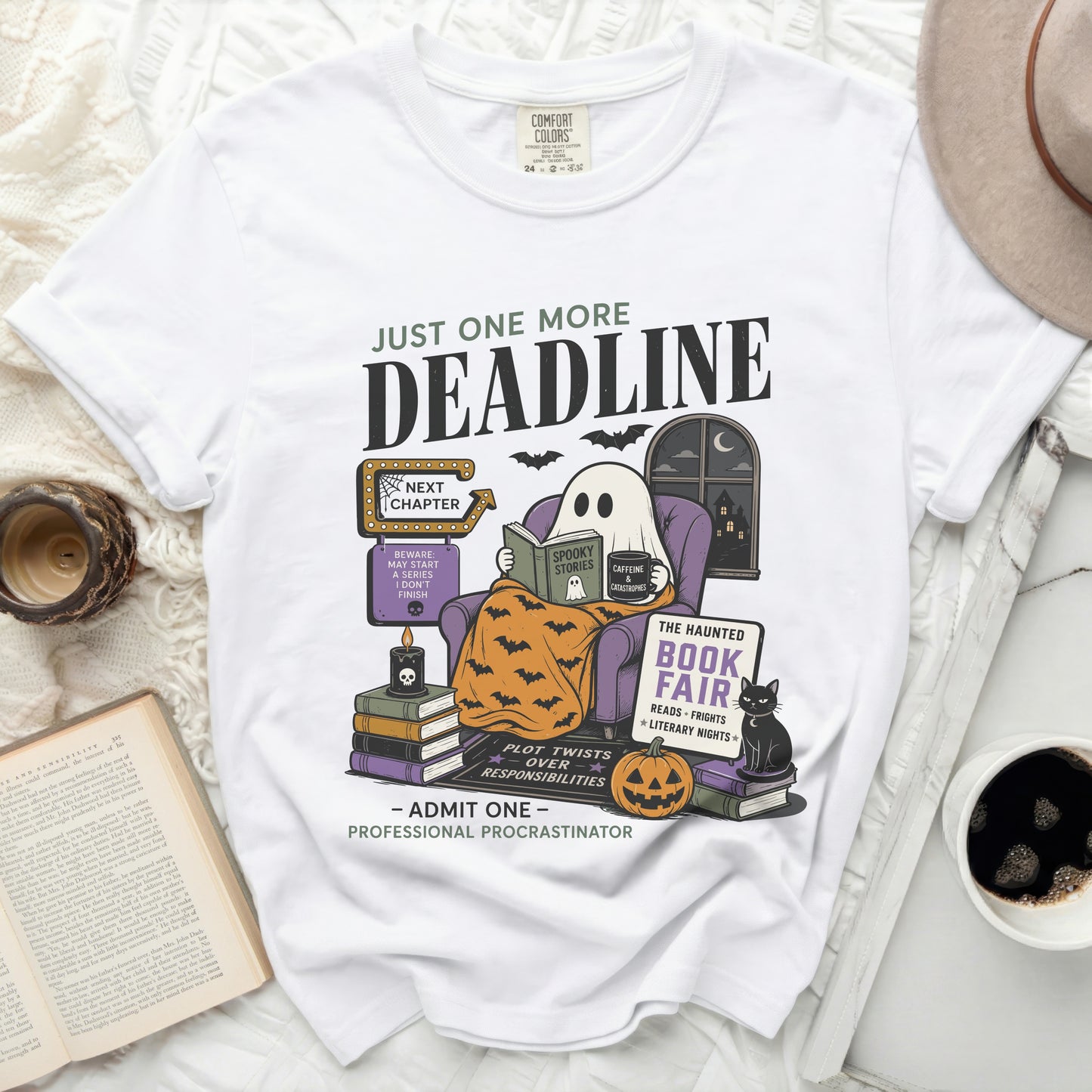 White t-shirt with a ghost reading and Halloween-themed art.