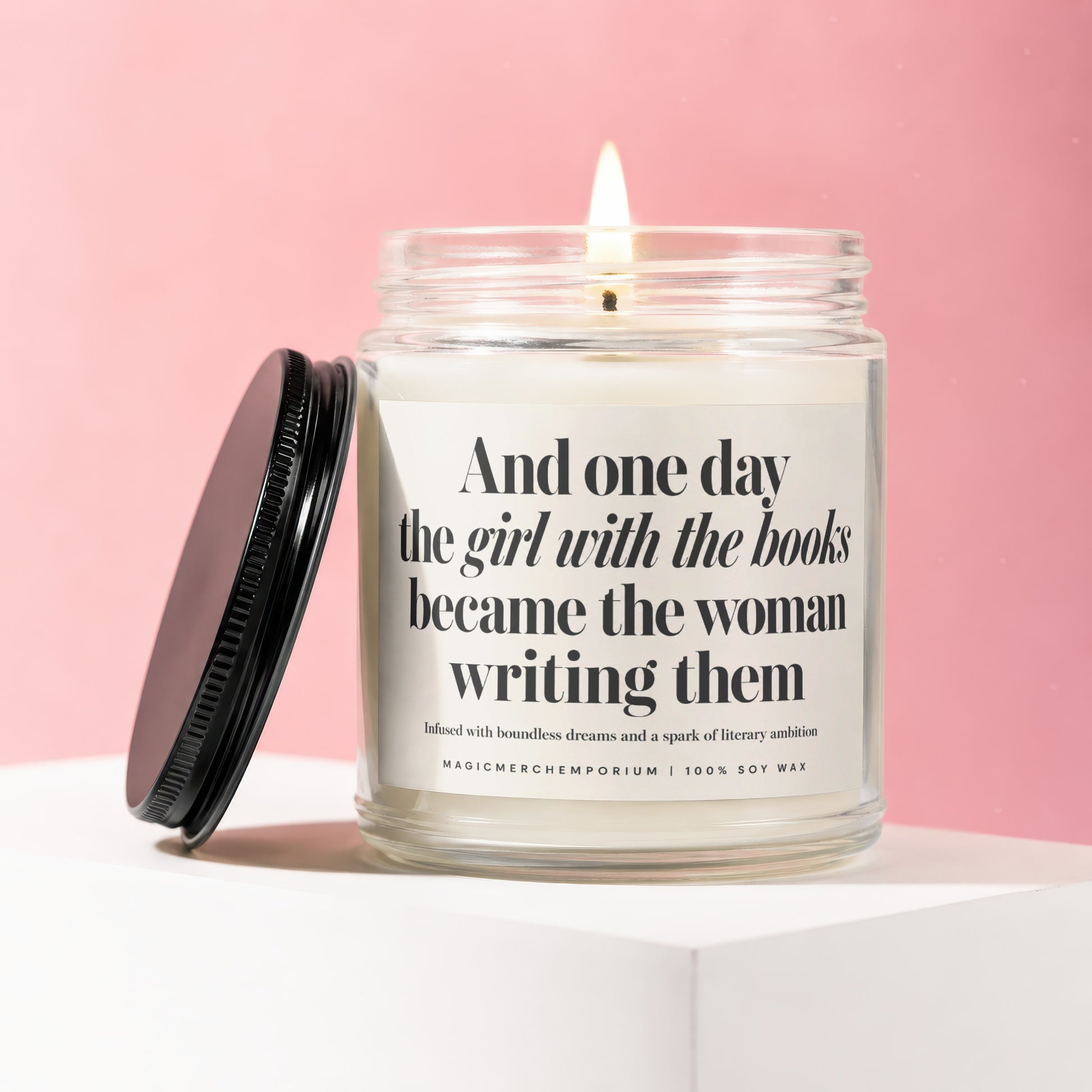 Lit soy wax candle with quote "And one day the girl with the books became the woman writing them".