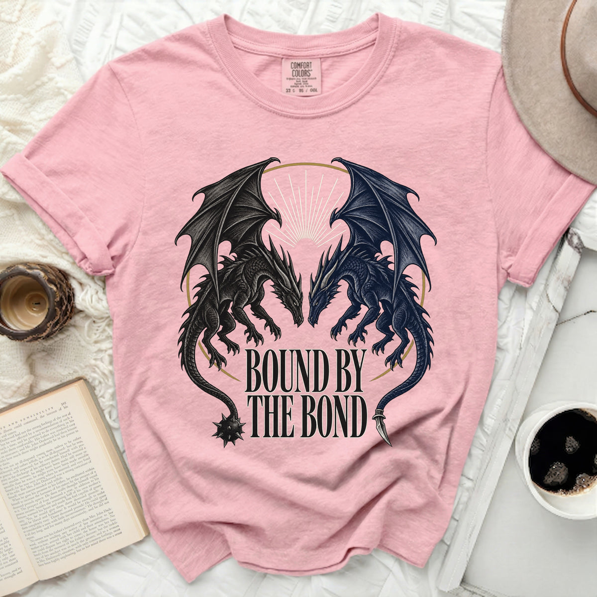 Pink t-shirt with two black dragons facing each other and text "Bound by the Bond."