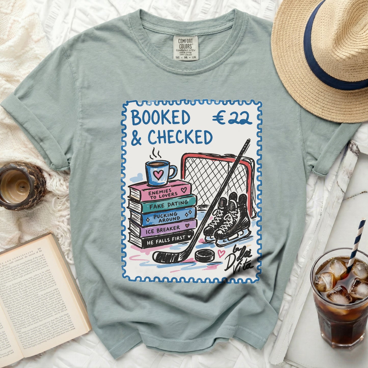 T-shirt with stamp graphic: "BOOKED €22 & CHECKED" and book titles.