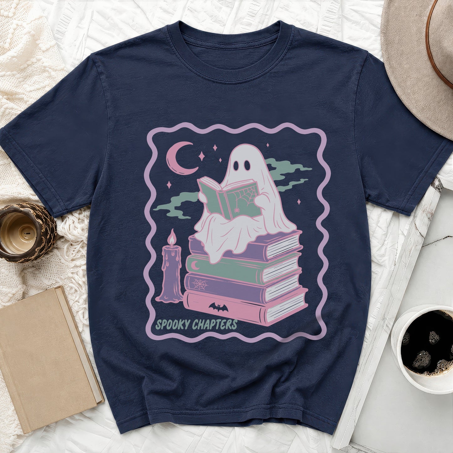 Navy t-shirt with a ghost reading a book on a stack of books and text.