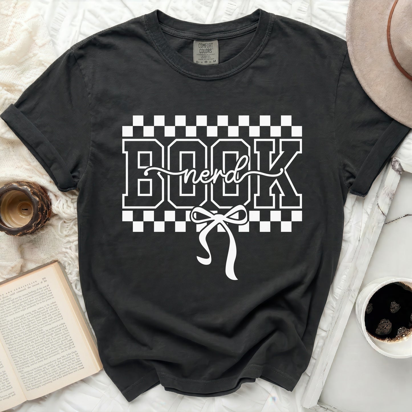 Black t-shirt with white "BOOK nerd" graphic and bow detail.