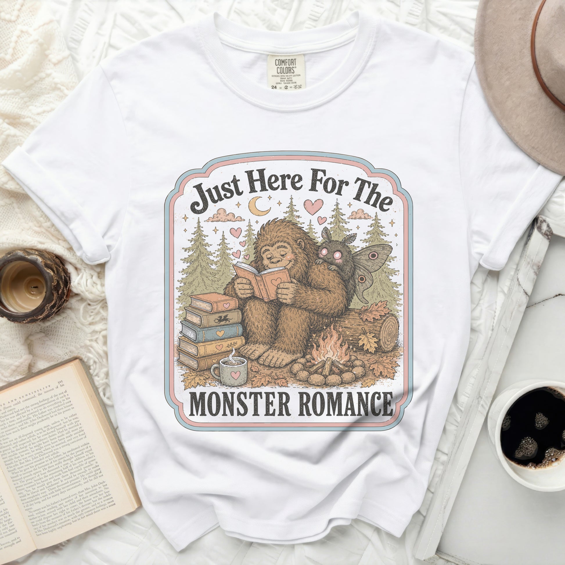 White t-shirt with Bigfoot and moth reading "Just Here For The Monster Romance" graphic.