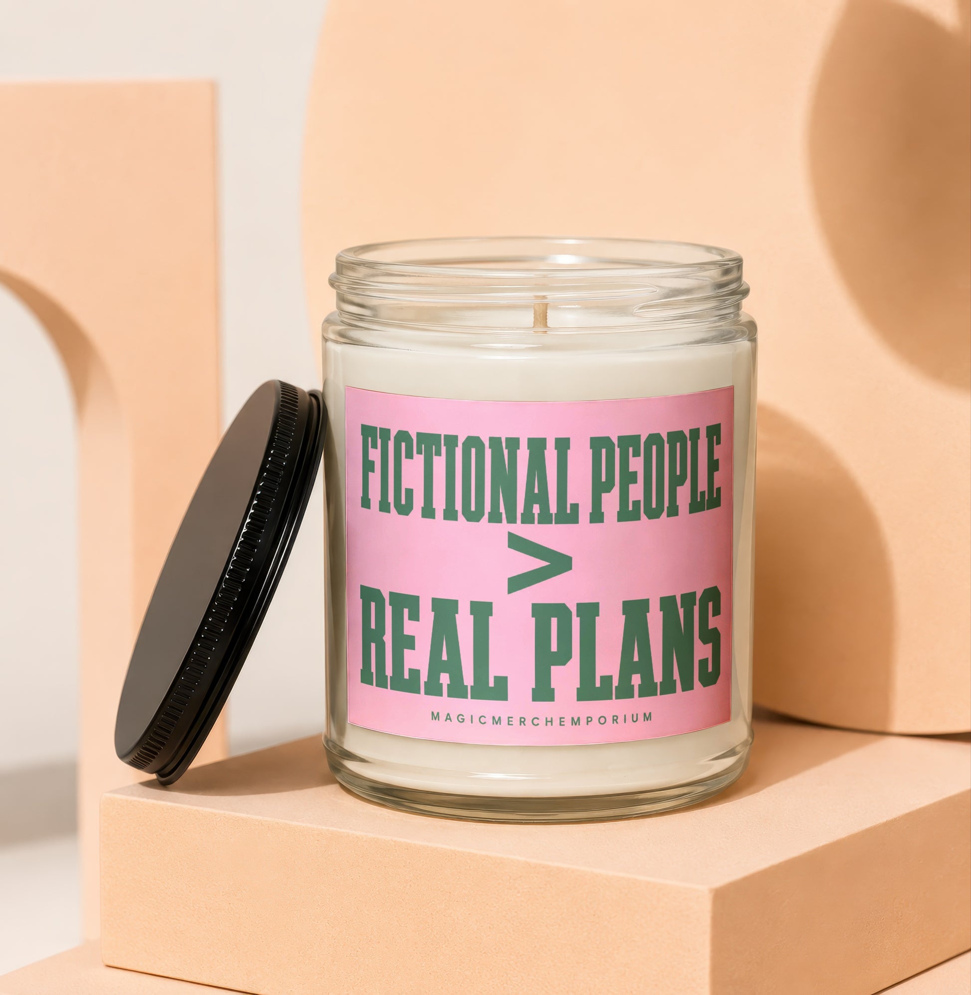 Jar candle with pink label reading "Fictional People > Real Plans" and small text.