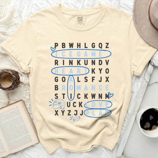 Cream t-shirt with word search featuring hockey, love, and romance.