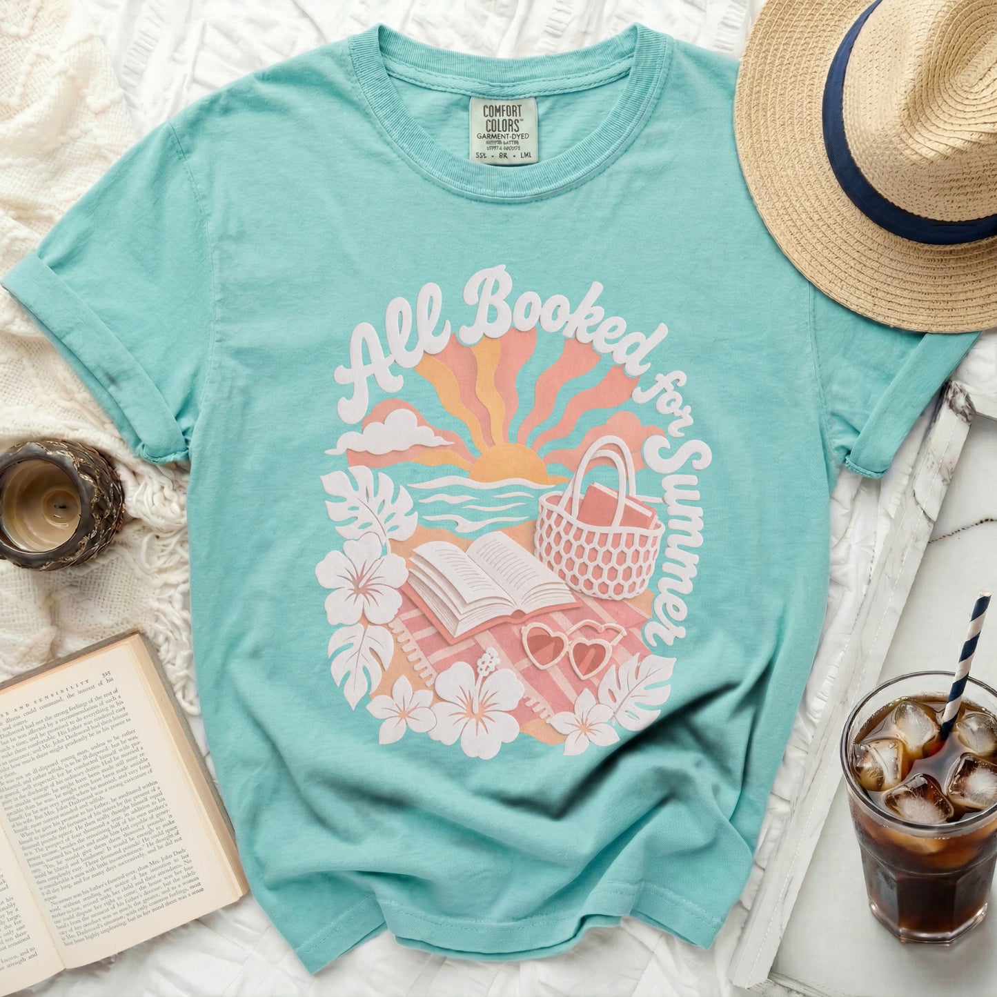 Teal t-shirt with "All Booked for Summer" graphic and books.