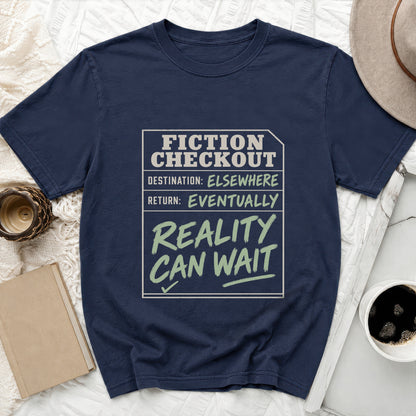 Navy t-shirt with "Fiction Checkout: Destination Elsewhere, Return: Eventually, Reality Can Wait" text.