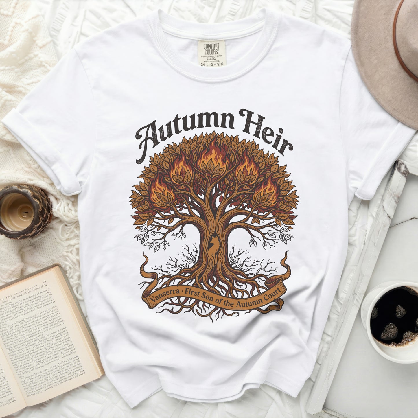 White t-shirt with "Autumn Heir" and a fiery tree design.
