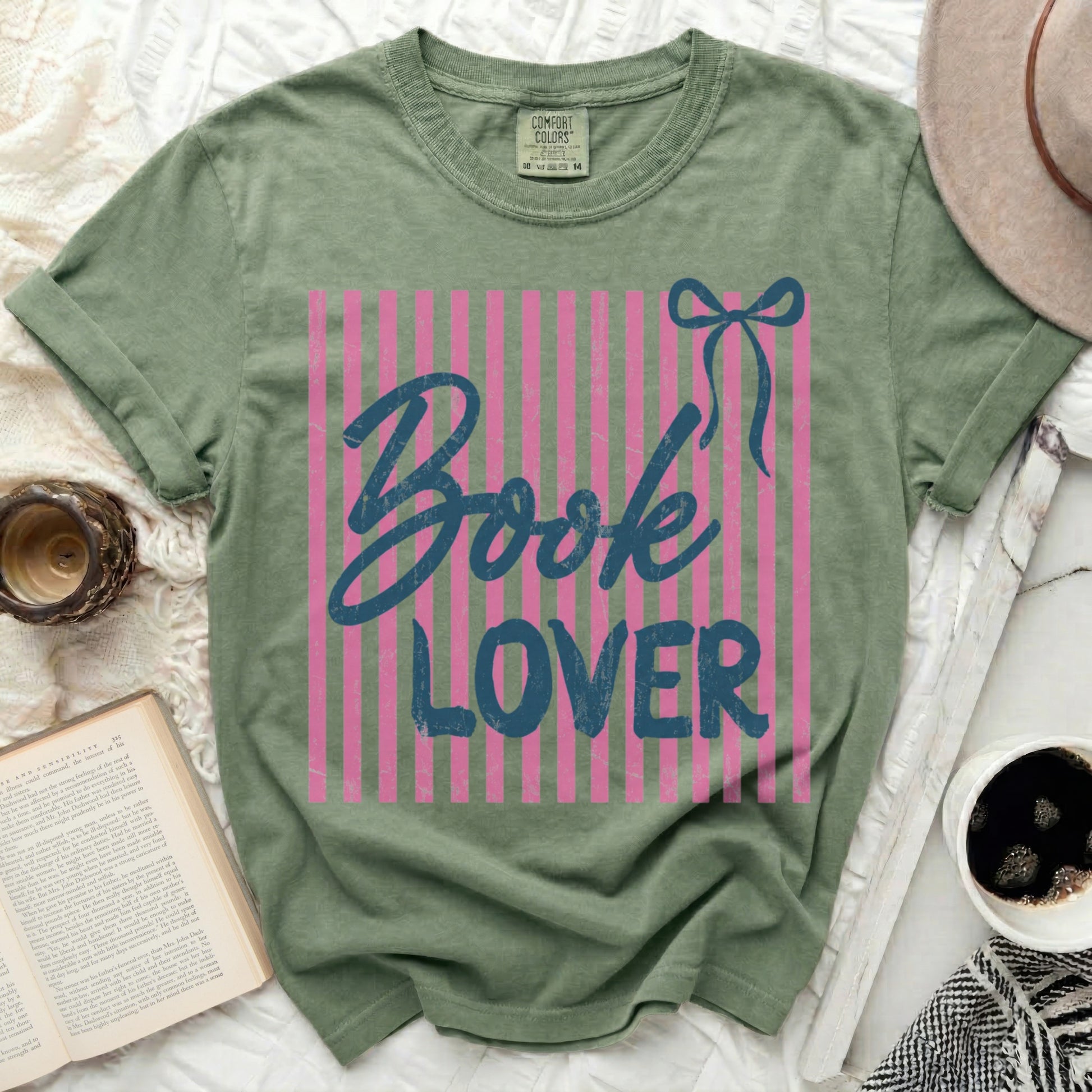 Green t-shirt with pink stripes and "Book Lover" graphic.
