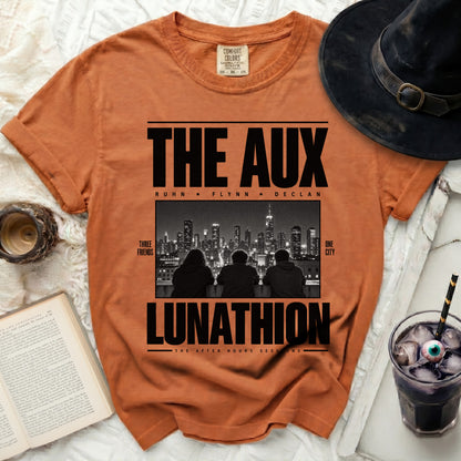 Orange t-shirt with "THE AUX LUNATHION" text and image of three friends and city skyline.