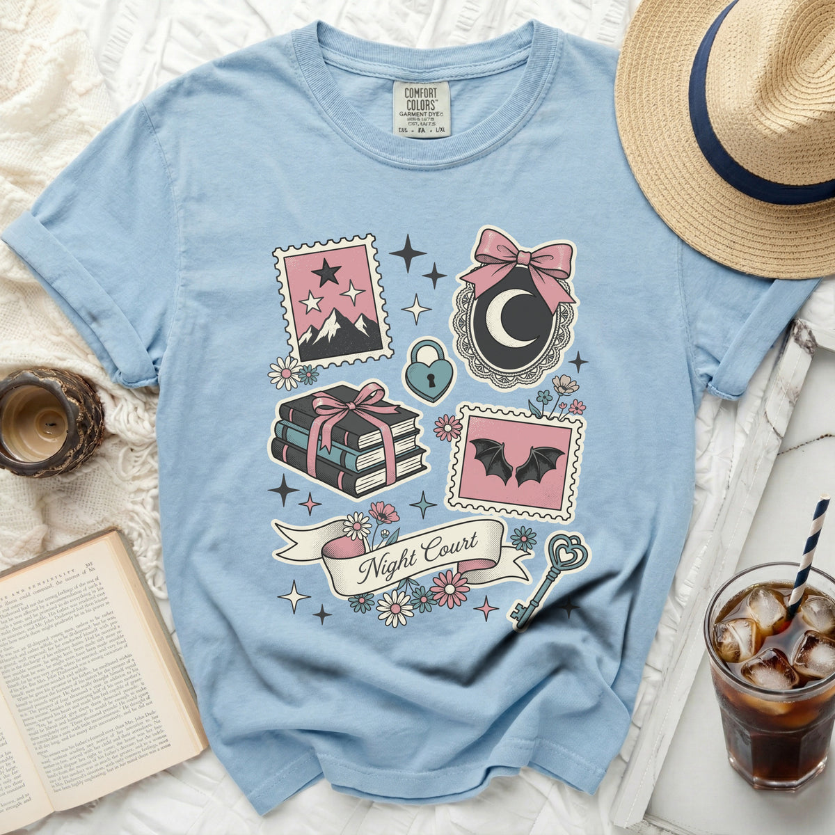 Light blue t-shirt with "Night Court" graphic and fantasy illustrations.