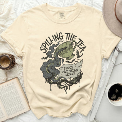 Cream t-shirt with "Spilling the Tea Since Pythian Began" graphic.