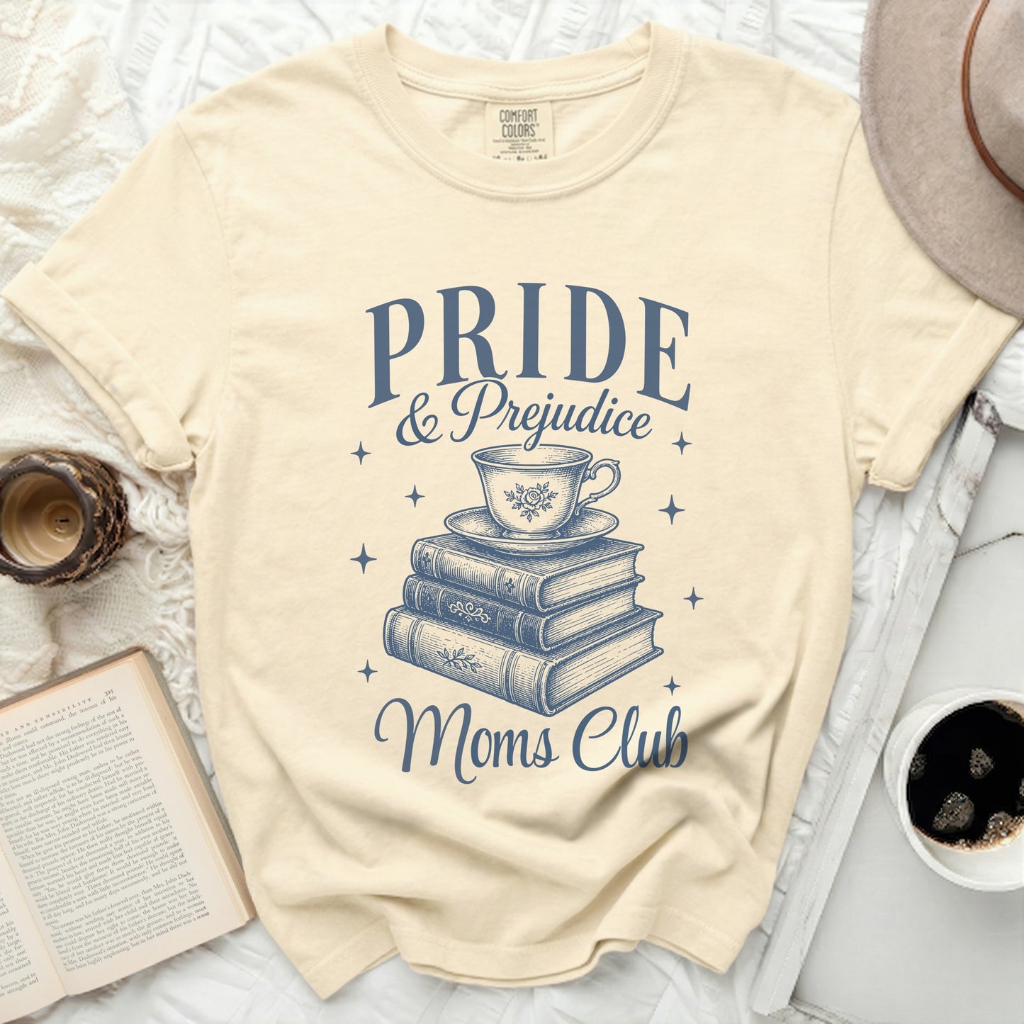 Pride & Prejudice Moms Club graphic on a cream t-shirt.