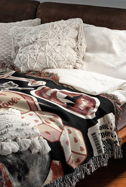 a cozy and inviting bedroom scene, featuring a bed with a black and white patterned blanket and a white pillow. The bed is positioned against a brown leather headboard, creating a warm and comfortable atmosphere.