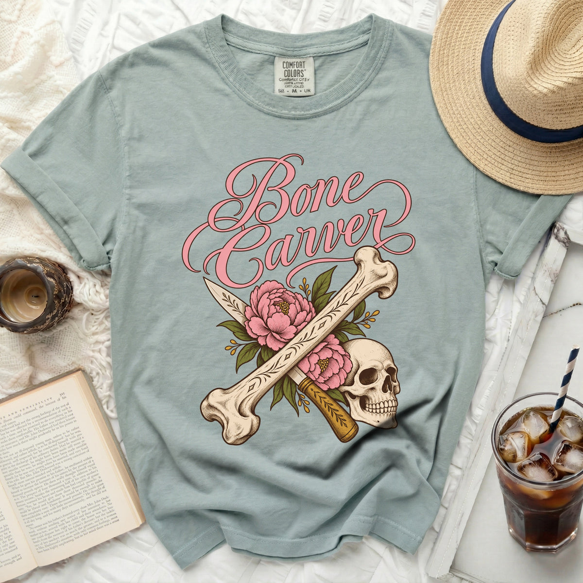 T-shirt with pink "Bone Carver" text, skull, bones, and flowers.