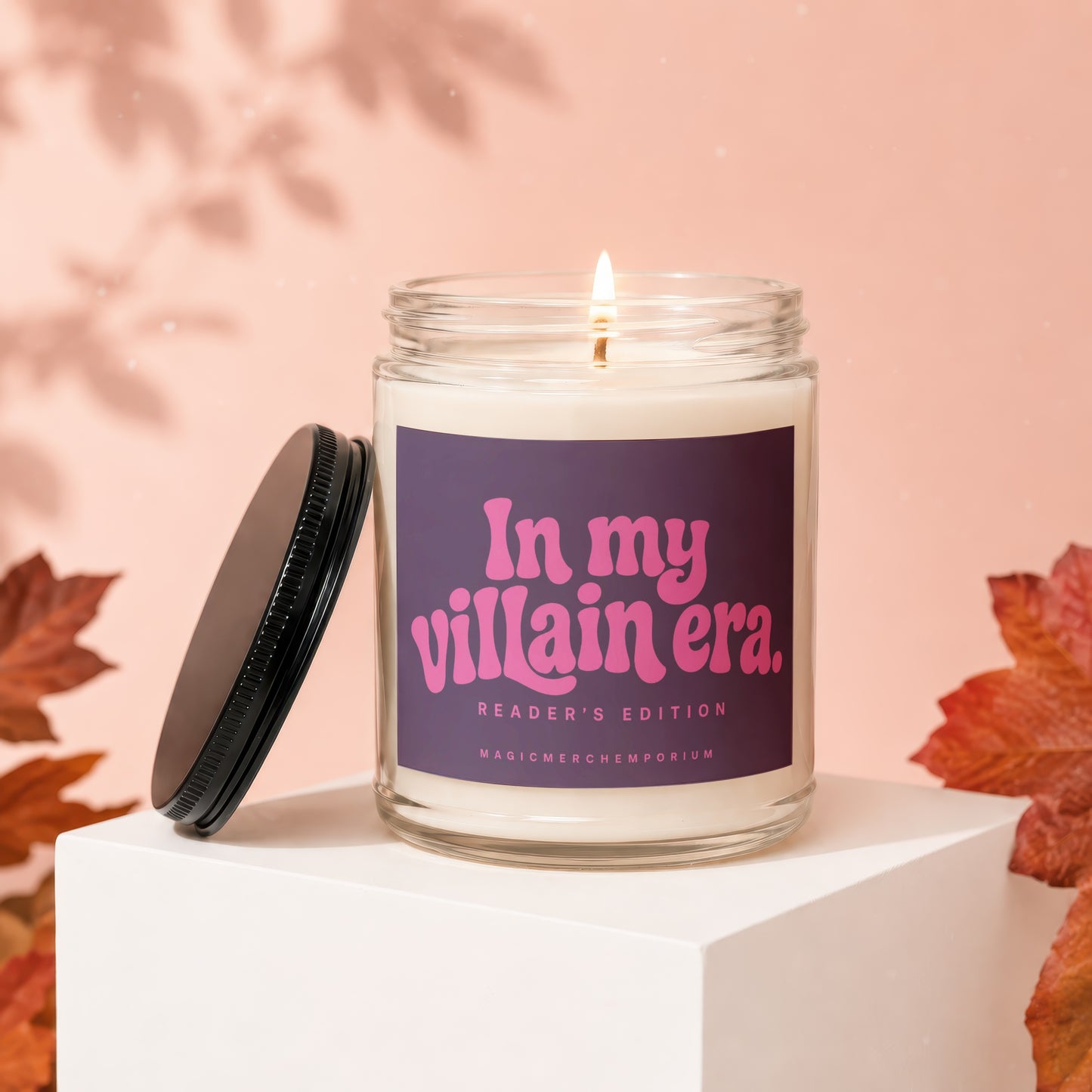 Glass jar candle with a dark purple label reading "In my villain era. READER'S EDITION MAGICMERCH.EMPORIUM".