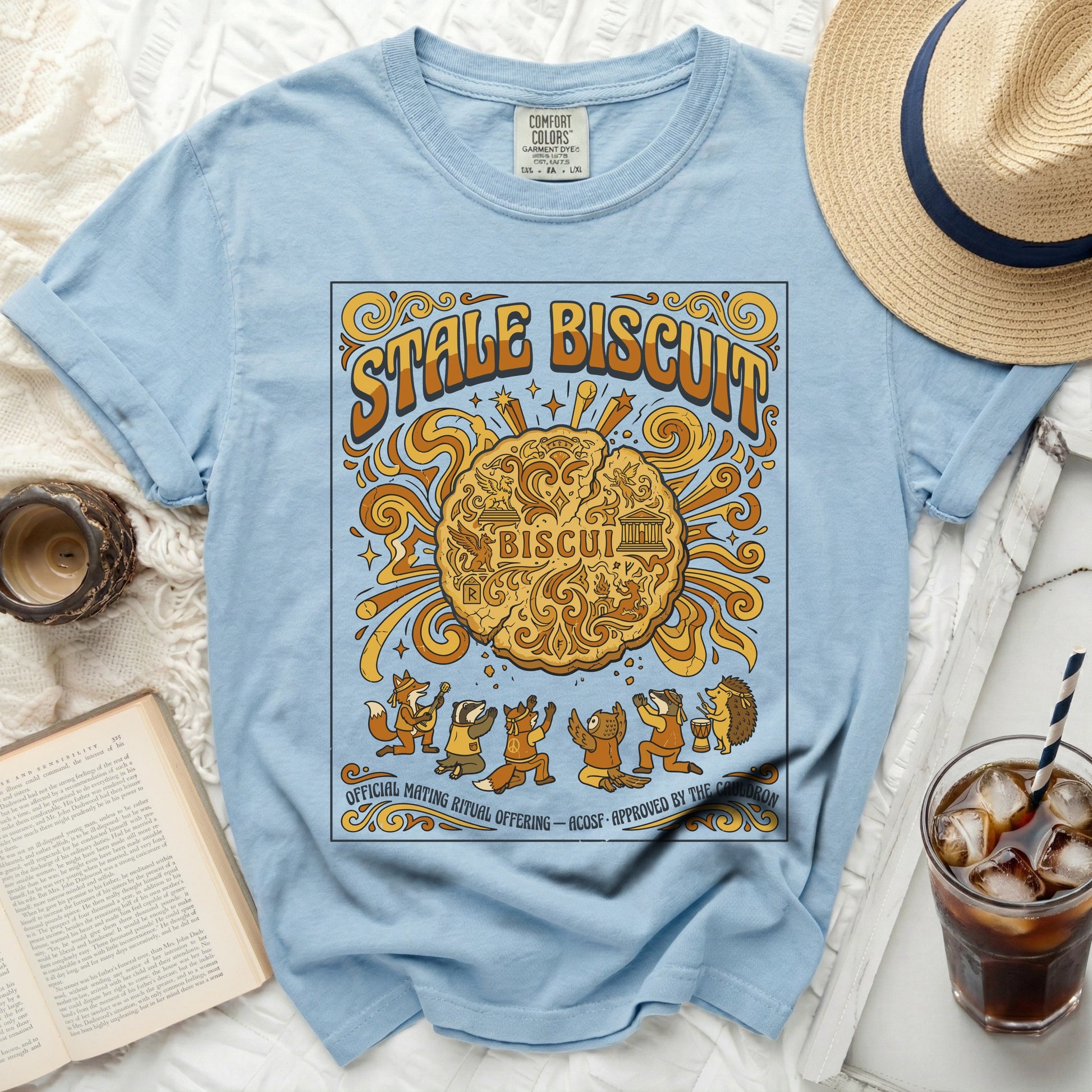 Light blue t-shirt with "Stale Biscuit" design featuring woodland creatures and text.