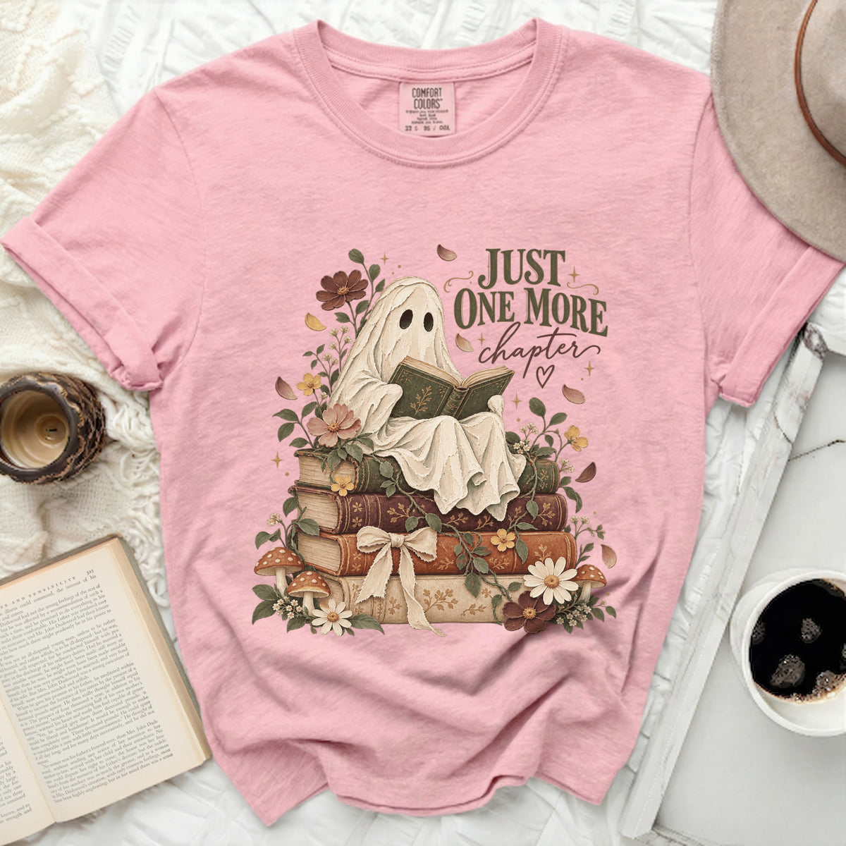Ghost reading book on stack of books with text "JUST ONE MORE chapter".