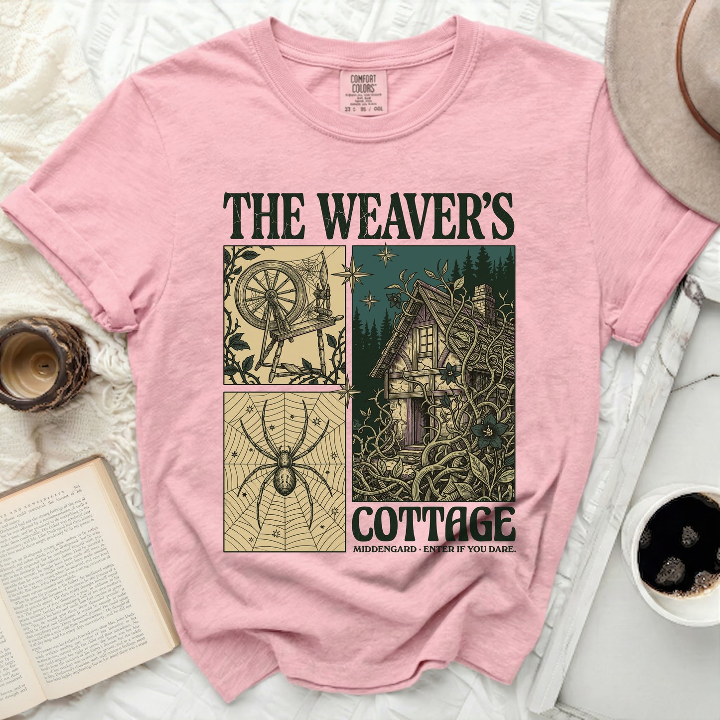 The Weaver's Cottage graphic tee with spinner, spider, and cottage illustrations.