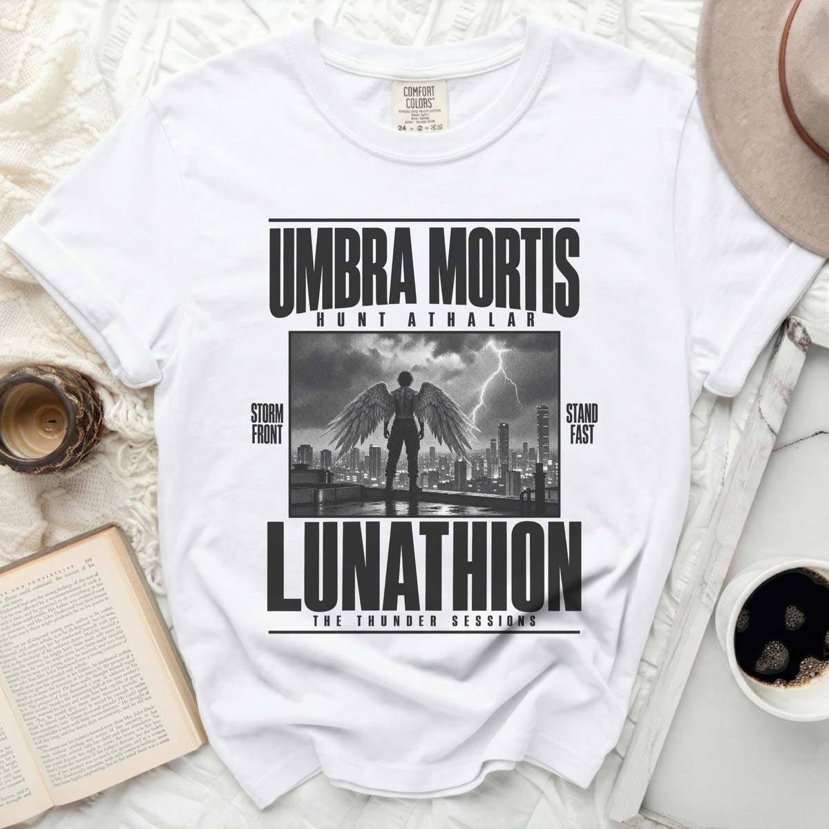 White t-shirt with "UMBRA MORTIS HUNT ATHALAR LUNATHION THE THUNDER SESSIONS" graphic.