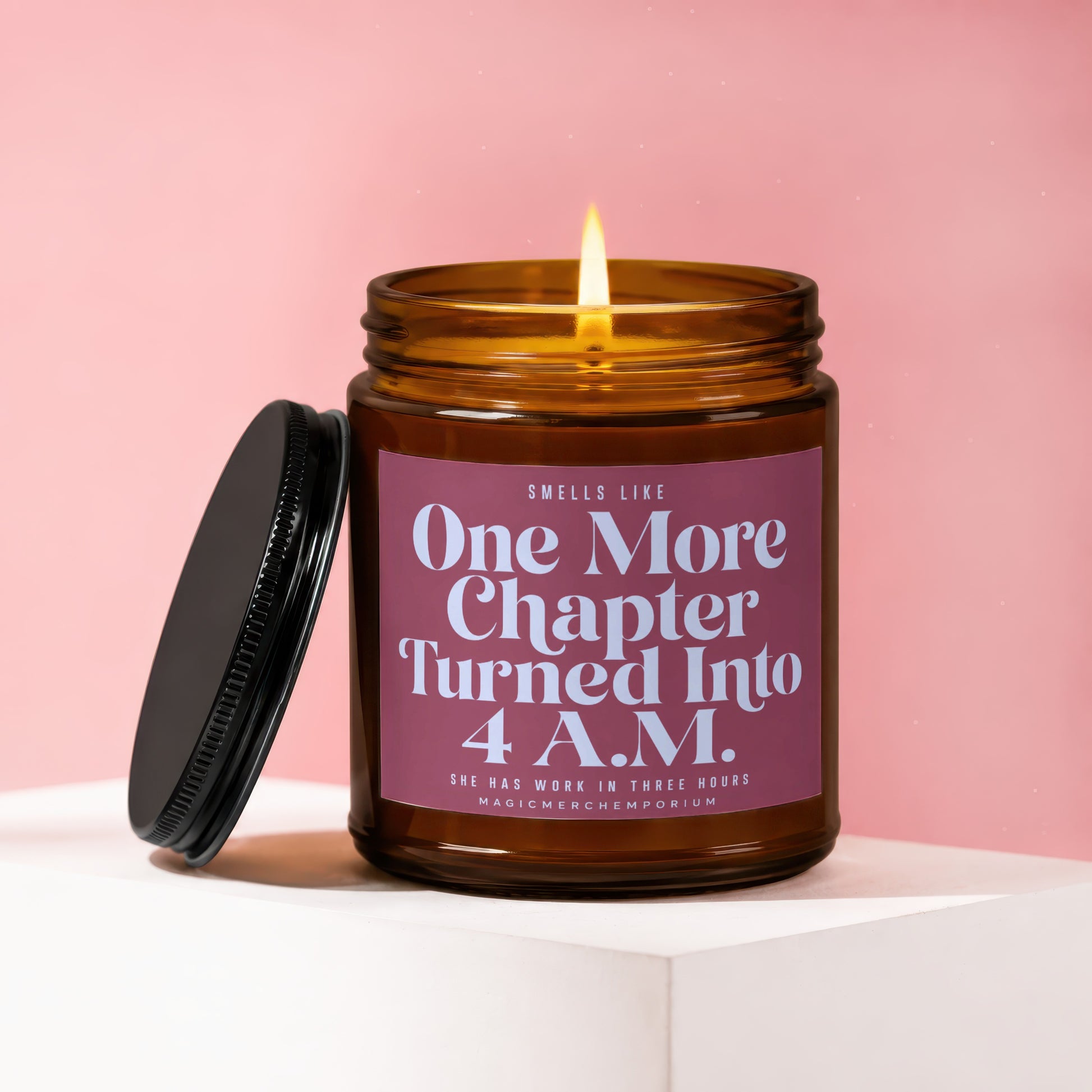 Amber jar candle with lit flame, reading "One More Chapter Turned Into 4 A.M."