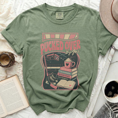Green t-shirt with "Pucked Over By You" hockey graphic.