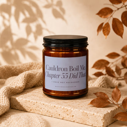 Amber candle with black lid featuring text "Cauldron Boil Me. Chapter 55 Did That."