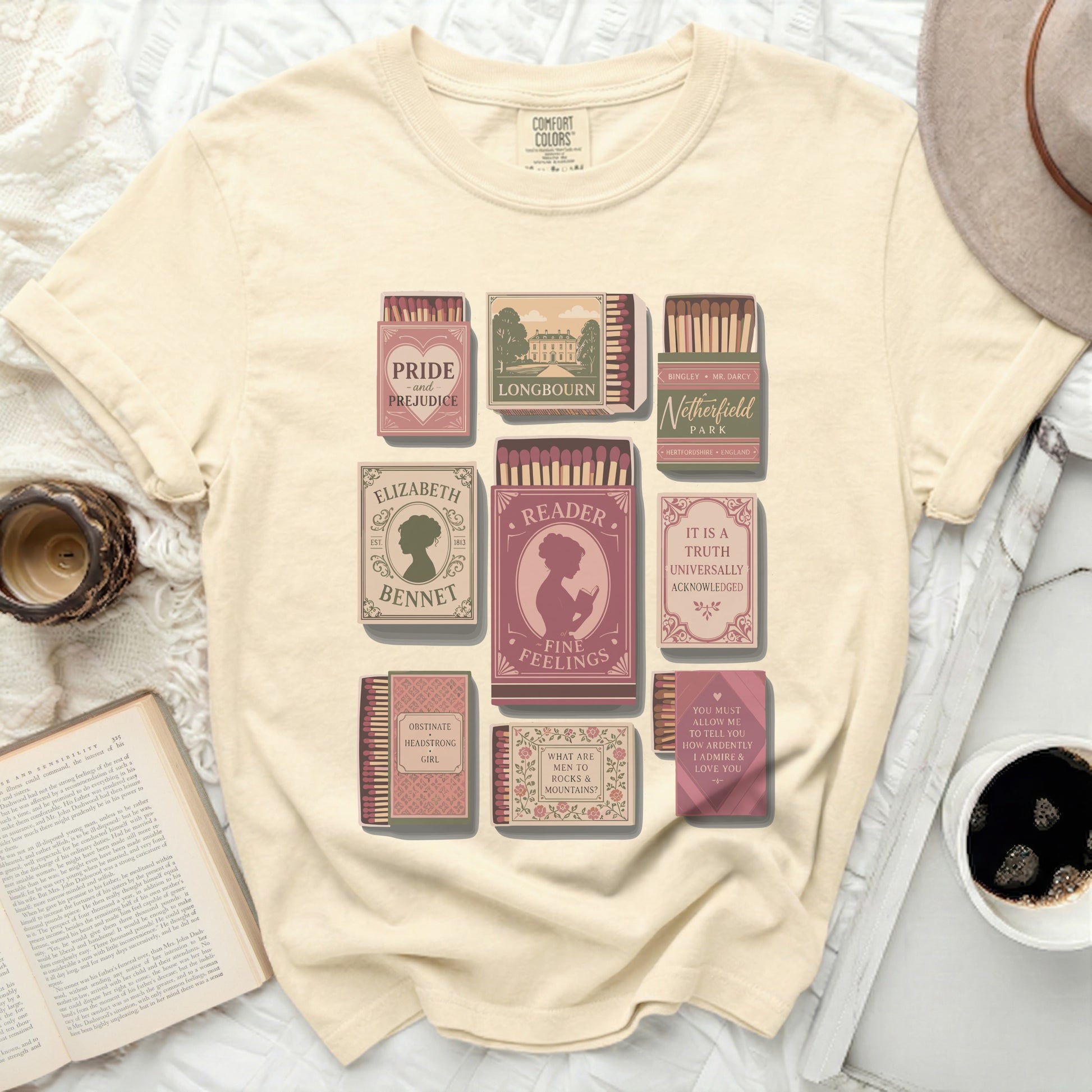 Cream t-shirt with literary-themed matchboxes: Pride & Prejudice, Longbourn, Netherfield.