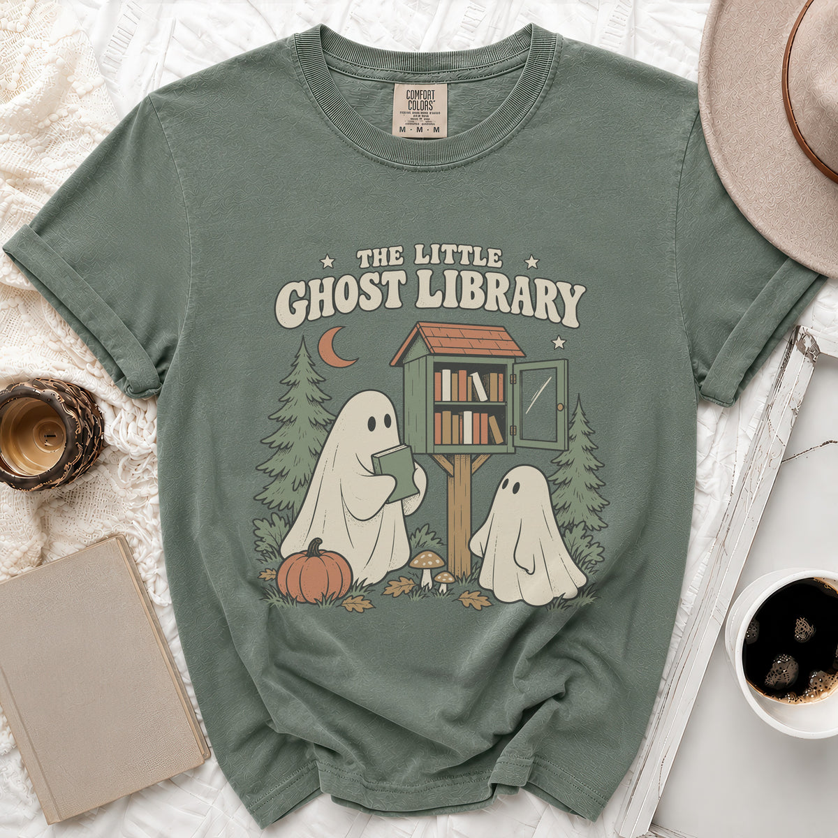 Green t-shirt with "The Little Ghost Library" text and ghost graphic.