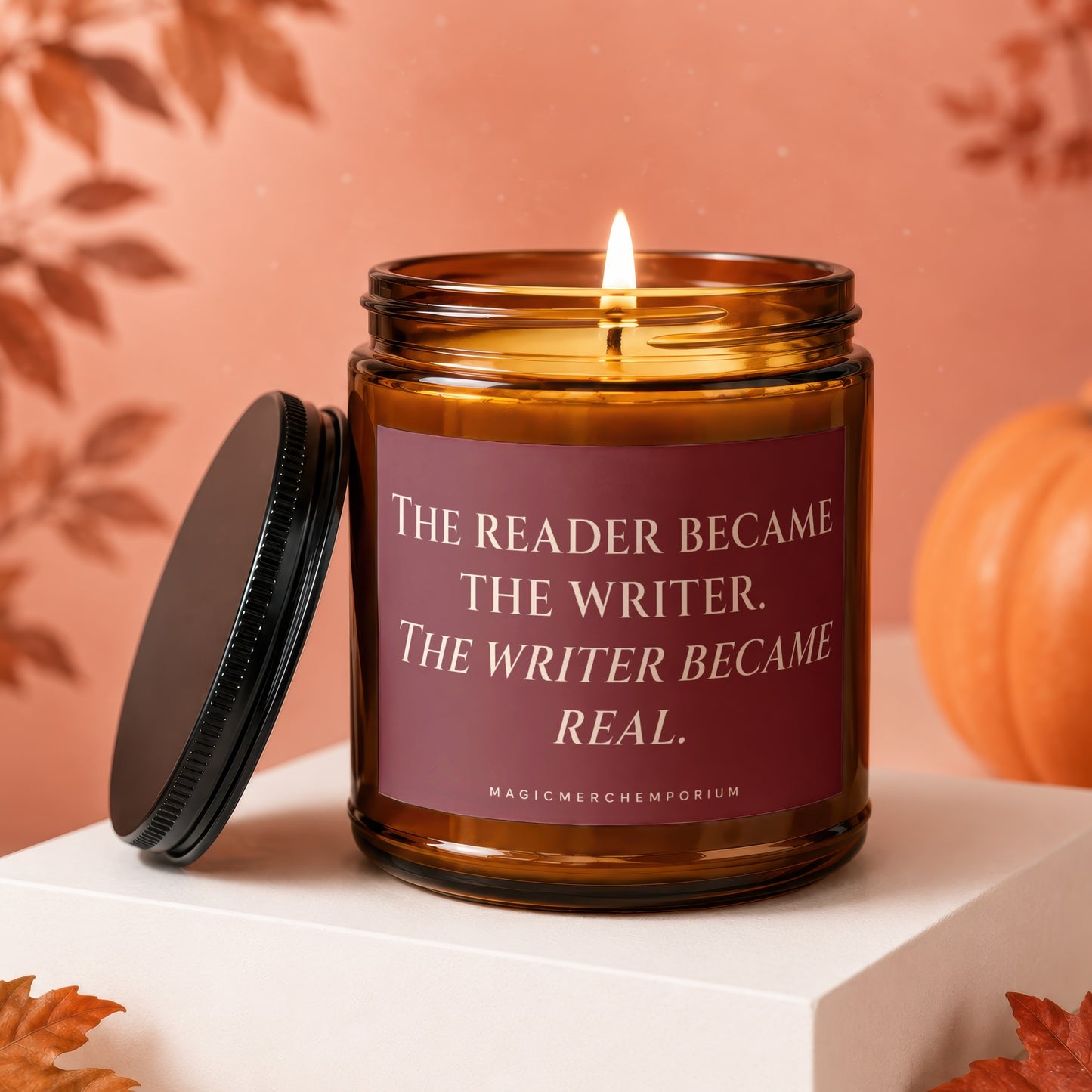 Candle with "The reader became the writer. The writer became real." text on label.