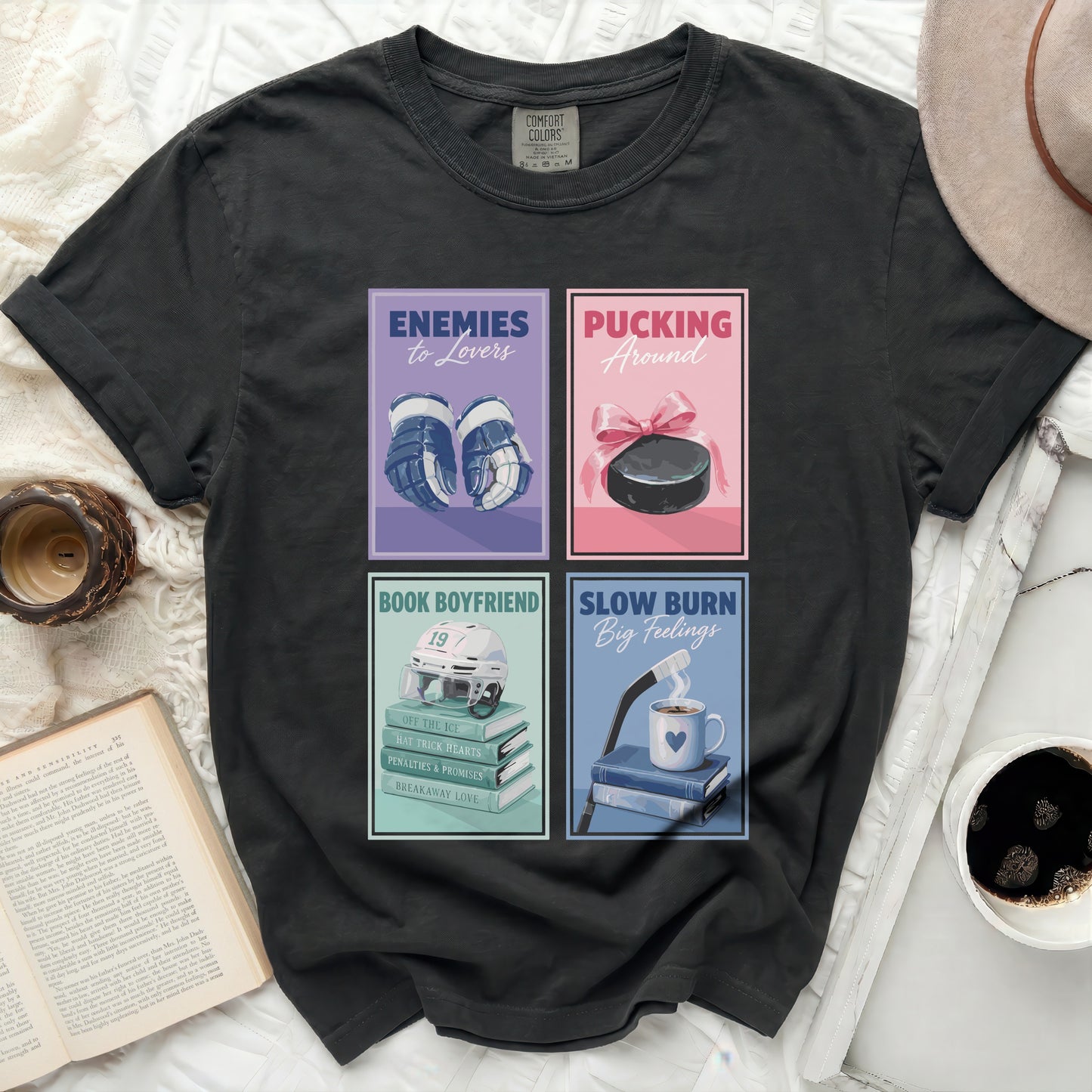 T-shirt with four graphic novel style book covers: hockey, puck, and romance themes.