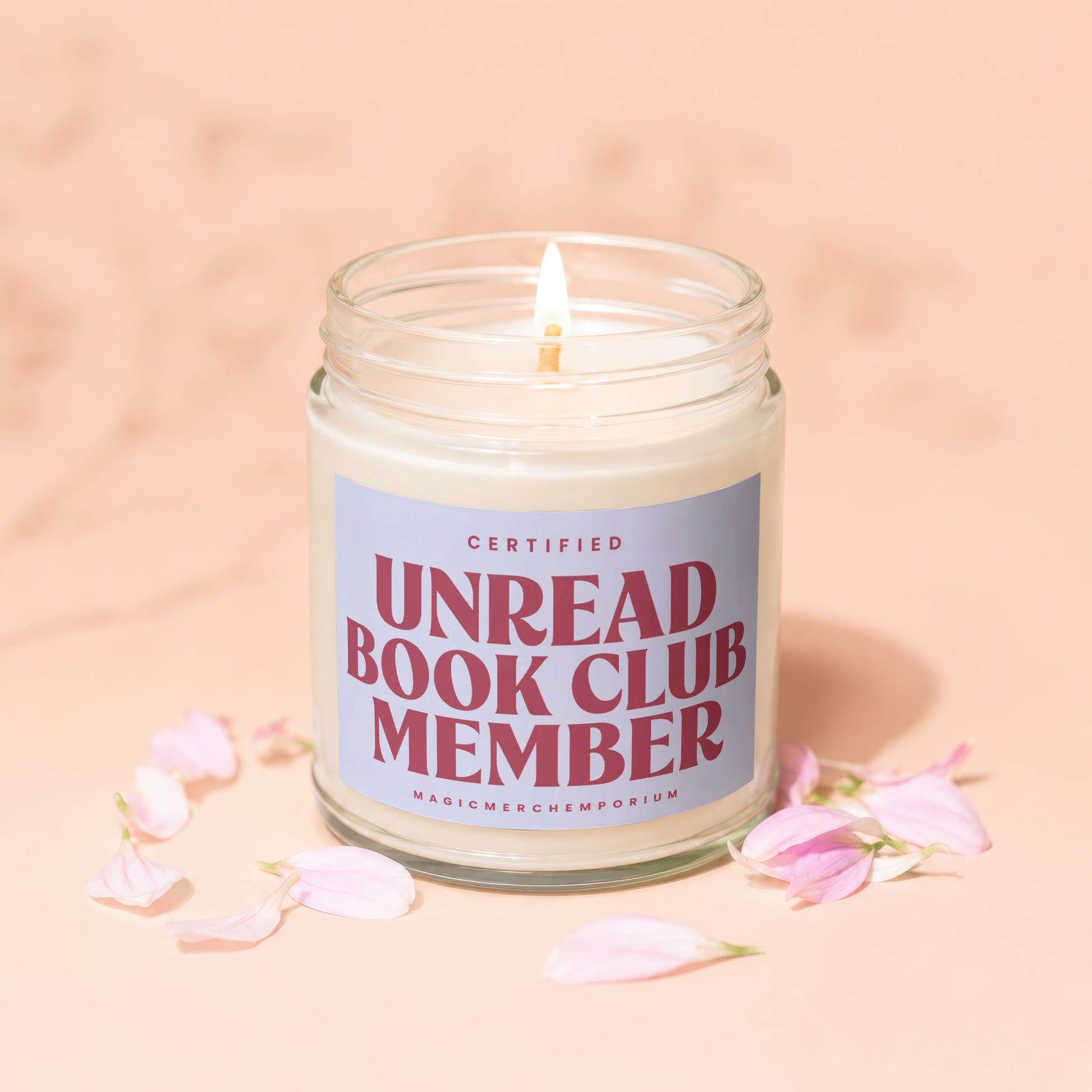 Lit candle in a jar with label "Certified Unread Book Club Member".