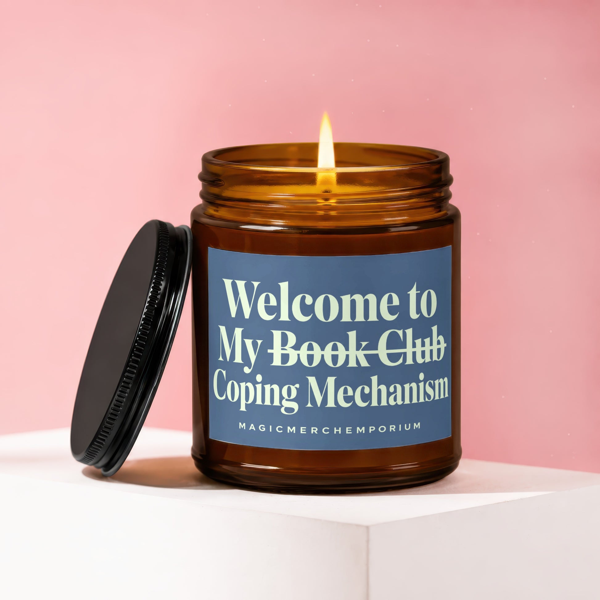 Amber glass candle with lit flame, "Welcome to My Book Club Coping Mechanism" text.