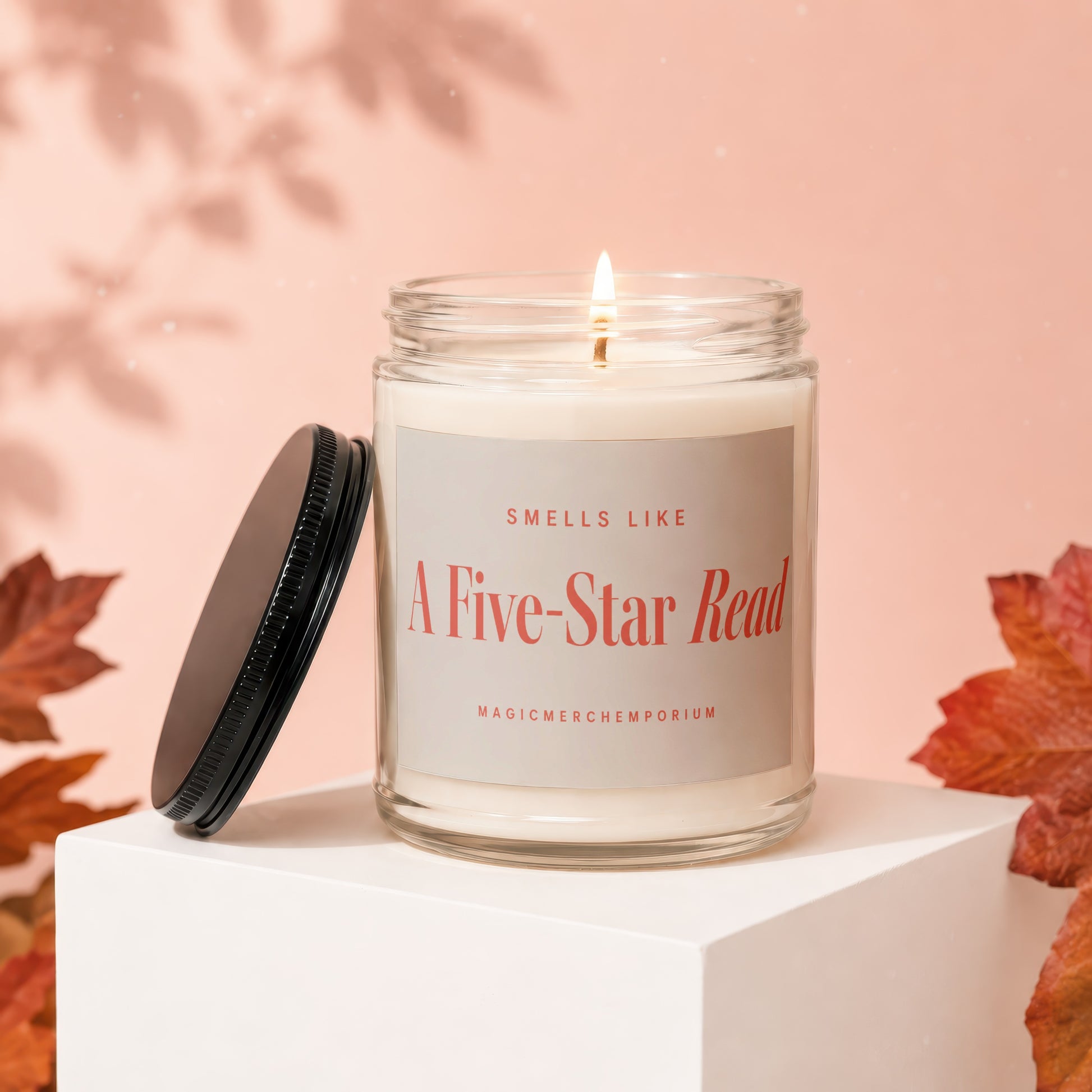 Candle with label "Smells Like A Five-Star Read" on a white block.