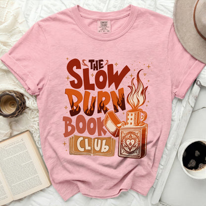 Pink t-shirt with "The Slow Burn Book Club" graphic and a lighter.