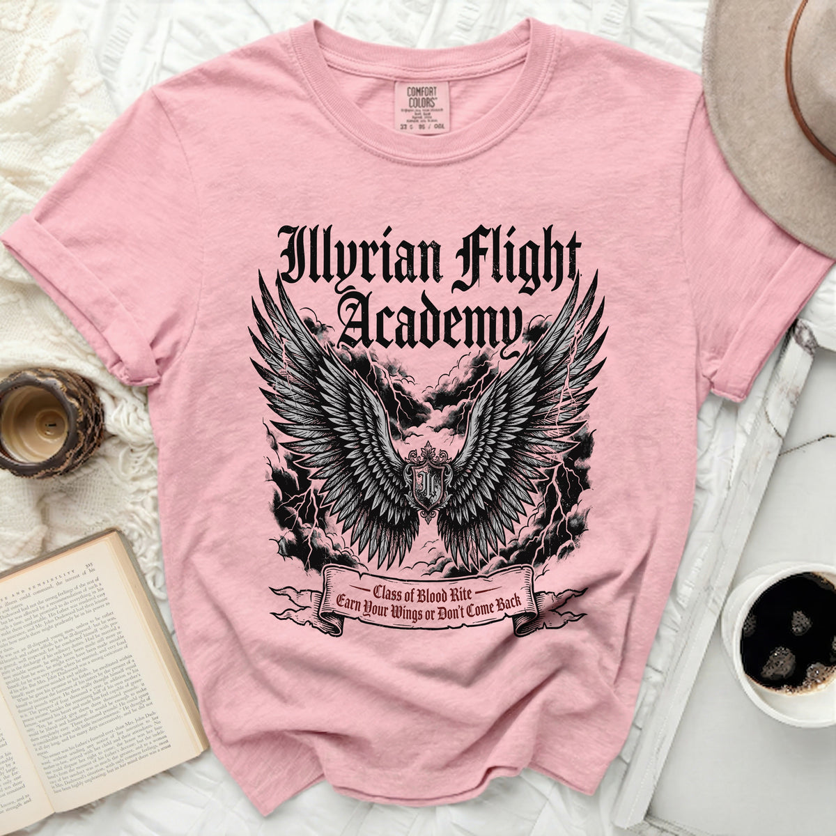 Pink Comfort Colors t-shirt with "Illyrian Flight Academy" graphic and wings.