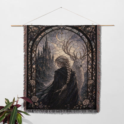 a tapestry hanging on a wall, depicting a woman with long braided hair standing next to a deer.