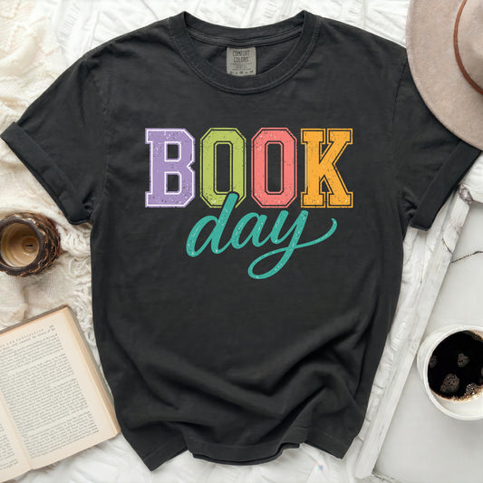 T-shirt with "BOOK day" in colorful block letters.