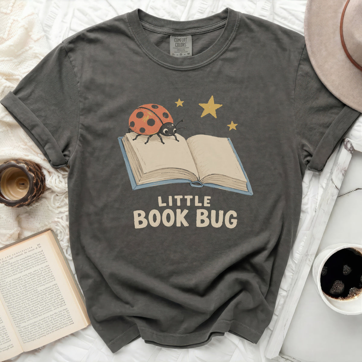 Dark grey t-shirt with "LITTLE BOOK BUG" and a ladybug on a book graphic.