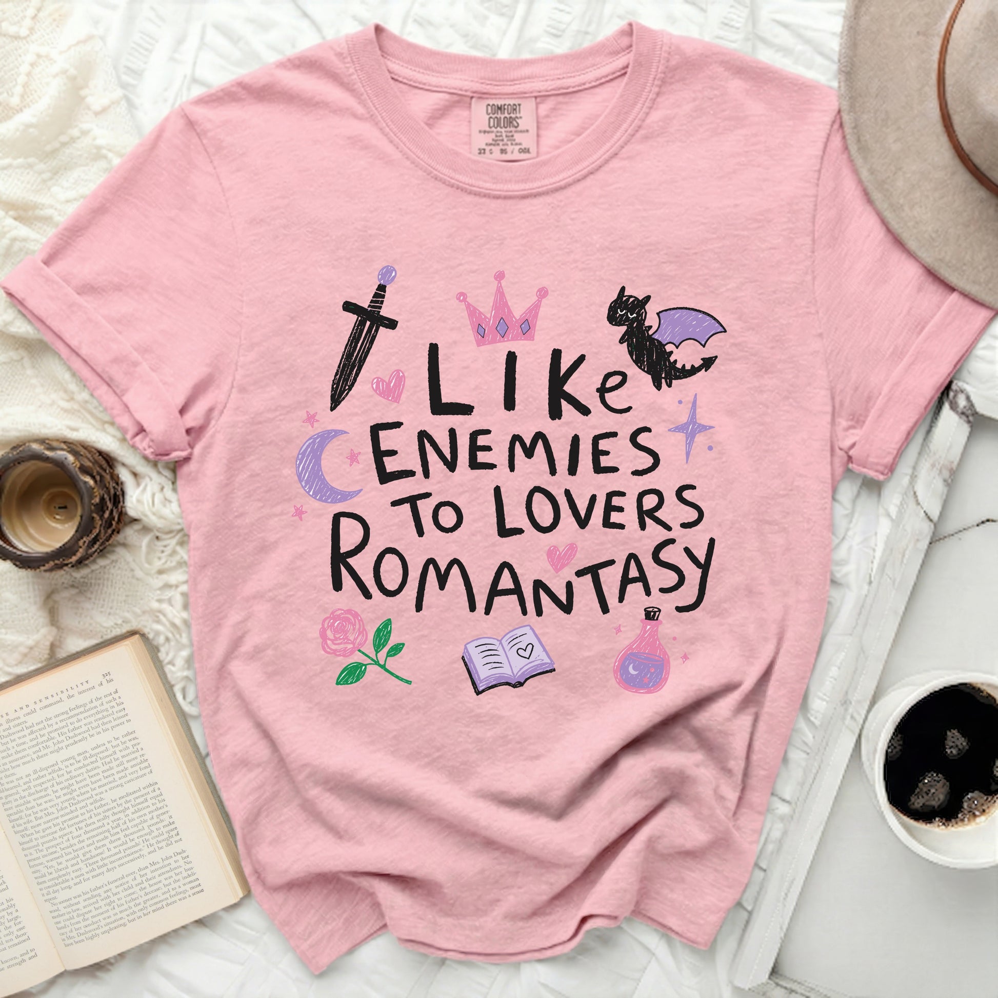 Pink t-shirt with "I Like Enemies to Lovers Romantasy" text and illustrations.