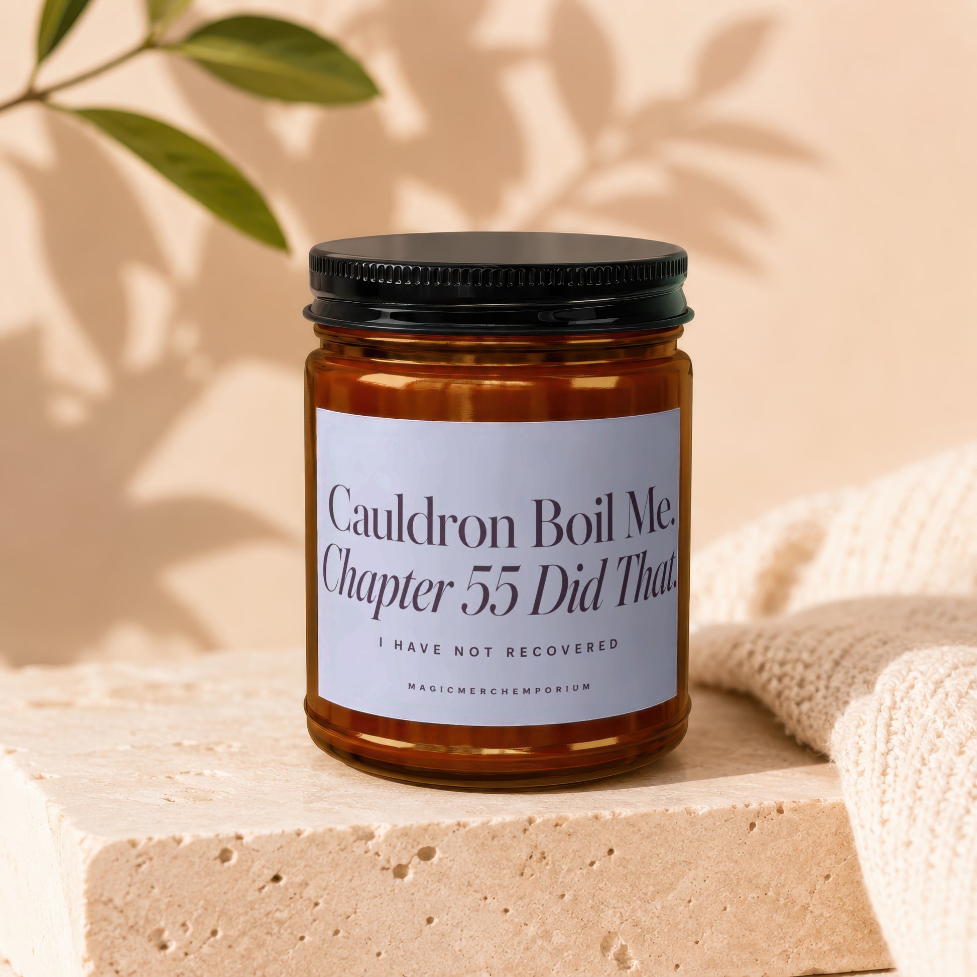 Amber glass candle with black lid, "Cauldron Boil Me. Chapter 55 Did That." text.