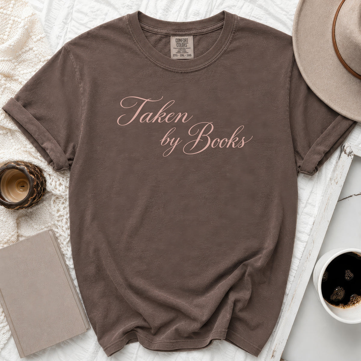 Brown t-shirt with pink text reading "Taken by Books", size 2XL.