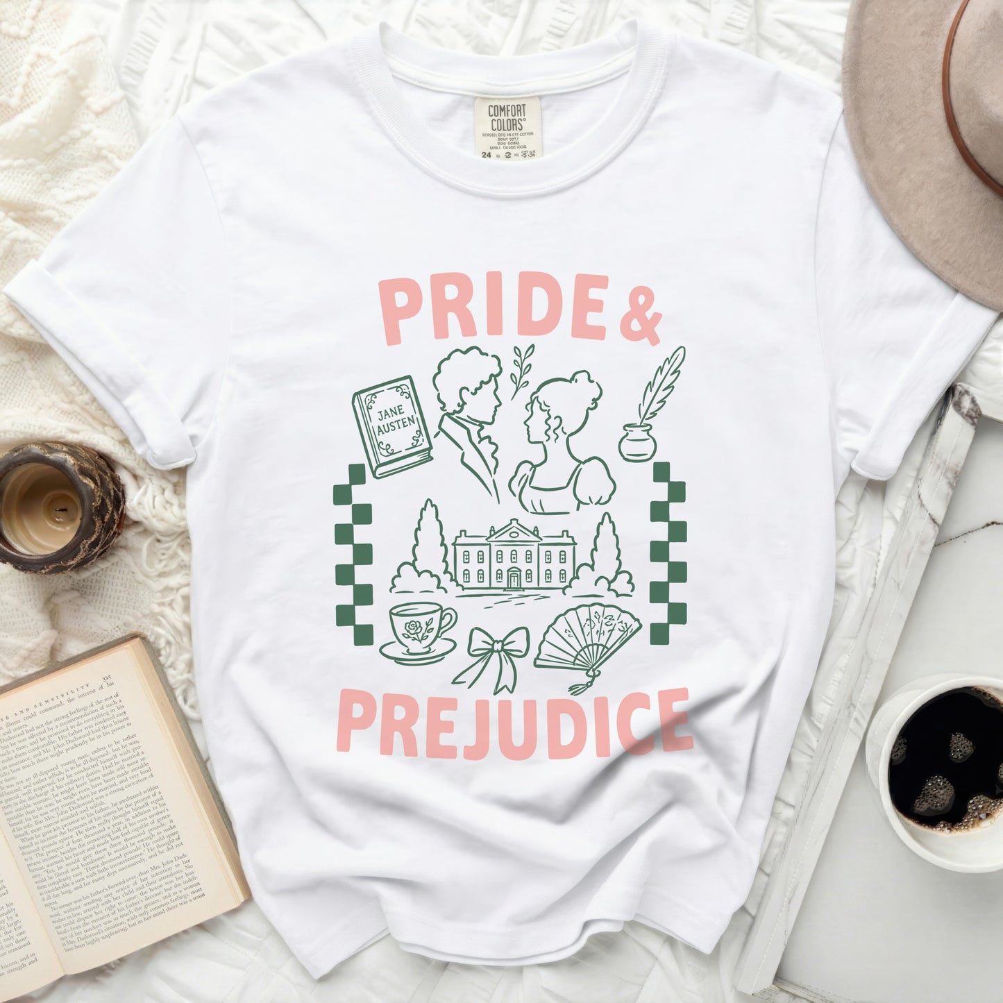 White t-shirt with Pride and Prejudice graphic featuring book, couple, and house.