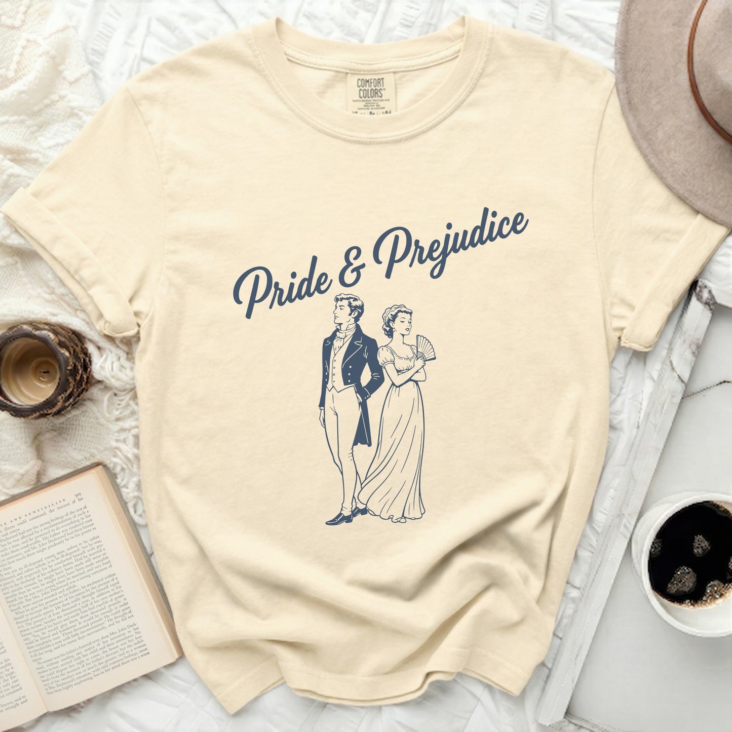 Cream t-shirt with "Pride & Prejudice" and Regency couple illustration.