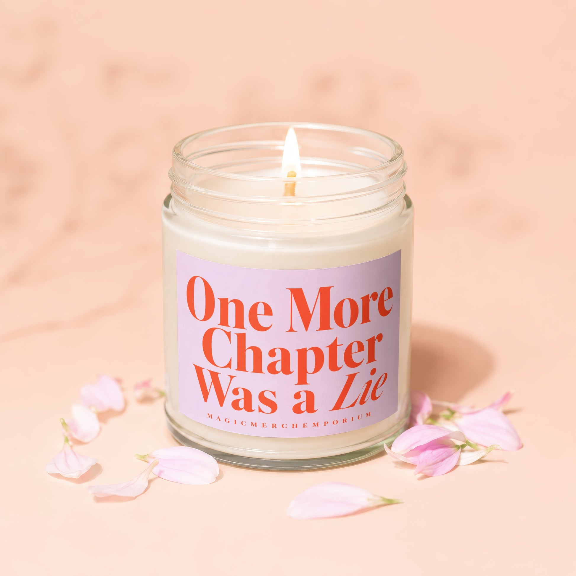 Lit candle in glass jar with label "One More Chapter Was a Lie".