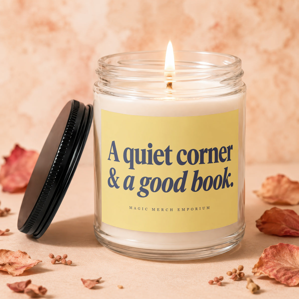 Lit candle in glass jar with yellow label reading "A quiet corner & a good book."