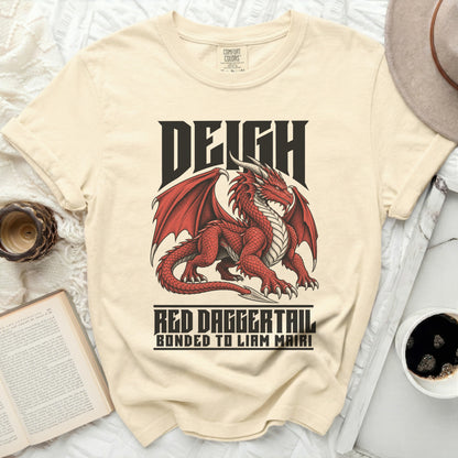Light yellow t-shirt with red dragon graphic and text "DEIGH RED DAGGERTAIL BONDED TO LIAM MAIRI".