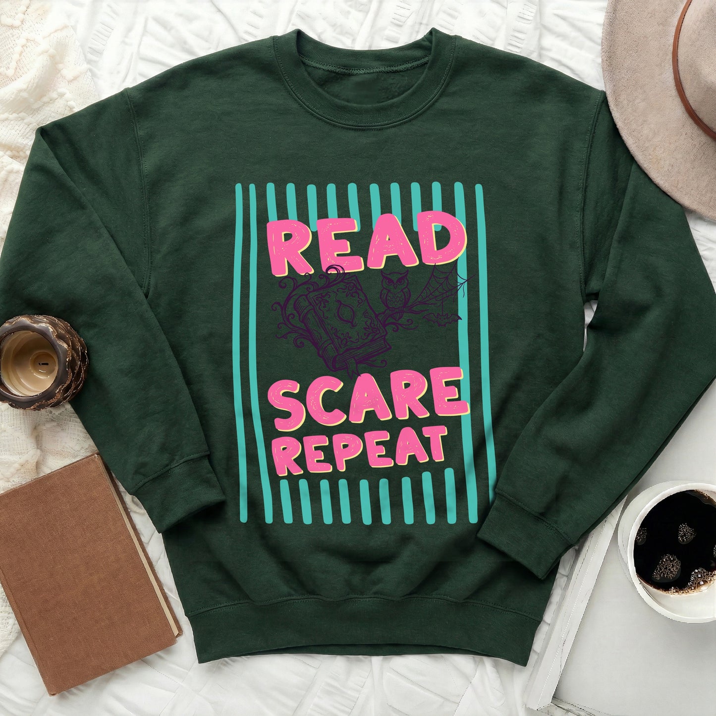 Green sweatshirt with "READ SCARE REPEAT" text and Halloween graphic.