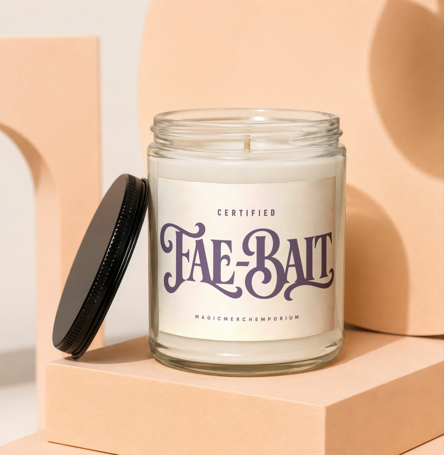Glass candle with "Fae-Bait" label and black lid.
