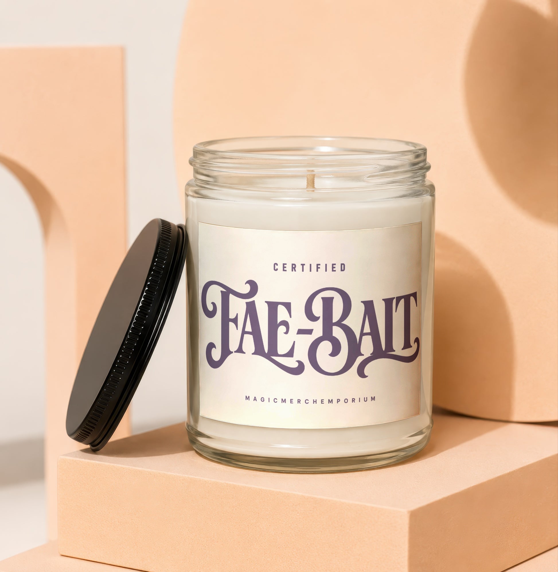 Glass candle with "Fae-Bait" label and black lid.